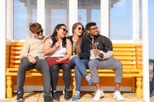 4 friends laughing on the beach