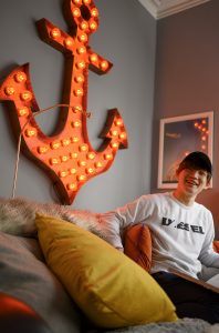 LSI/IH Portsmouth student laughing on sofa in living room