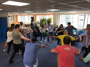 LSI/IH Portsmouth students dance salsa in student lounge